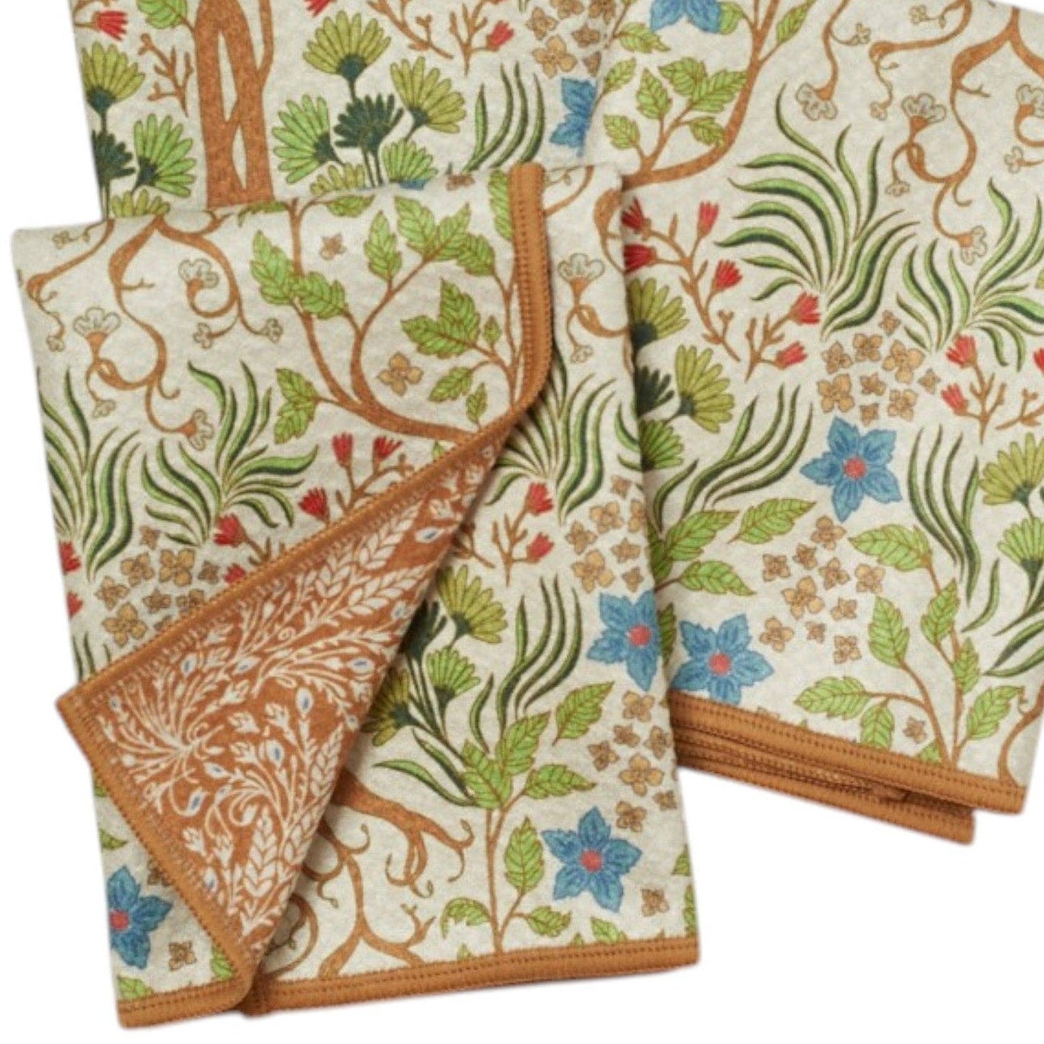 Wooden spoon on a decorative cloth with tree and floral pattern