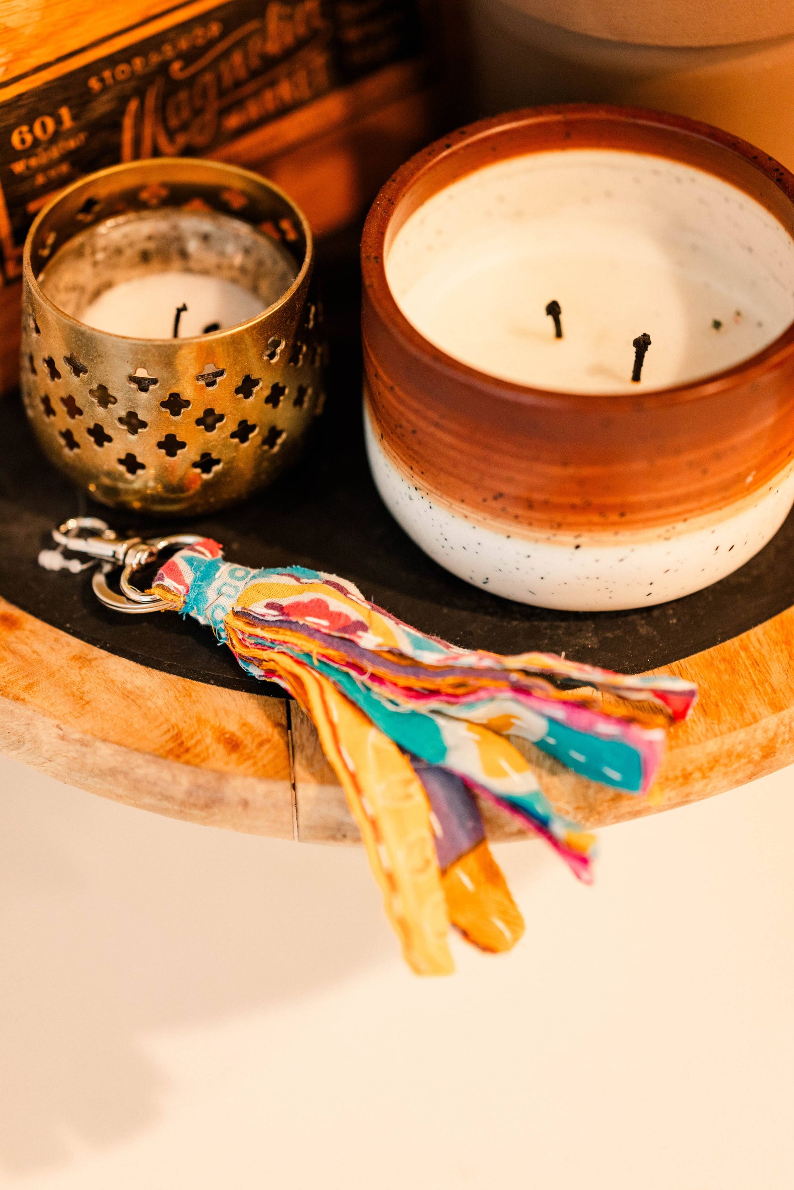 Colorful fabric keychain on a woven basket with a light background