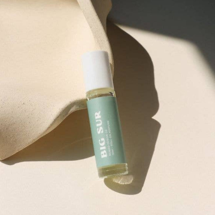 Small bottle labeled 'BIG SUR' on a beige surface with soft shadows