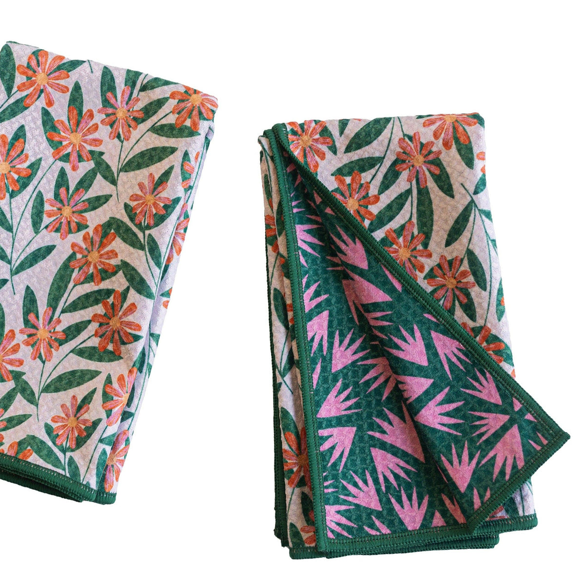 Two folded towels with floral patterns on a white background