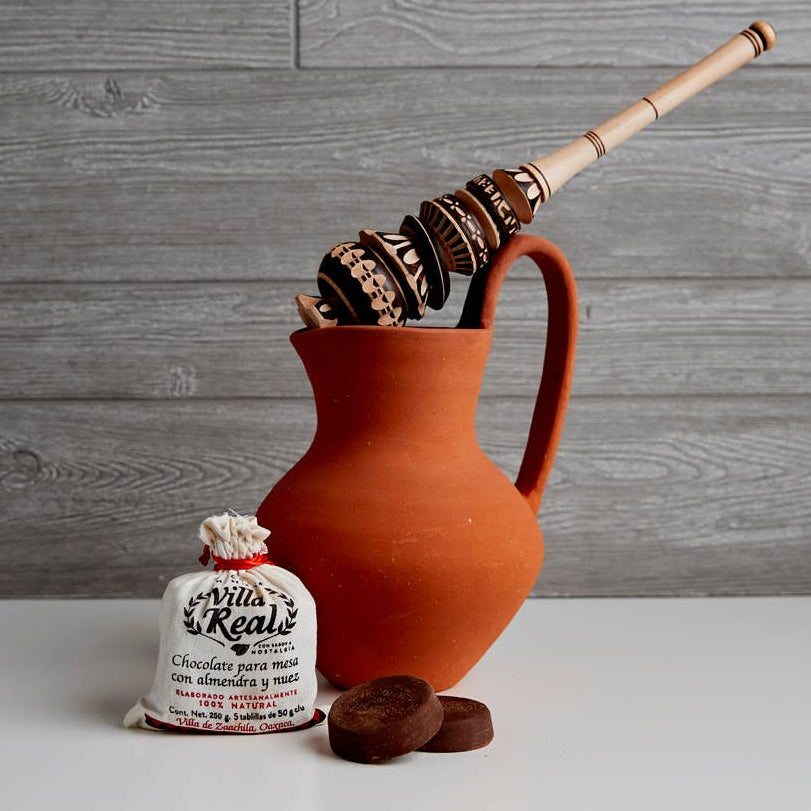 Terracotta pitcher with molinillo for Mexican hot chocolate