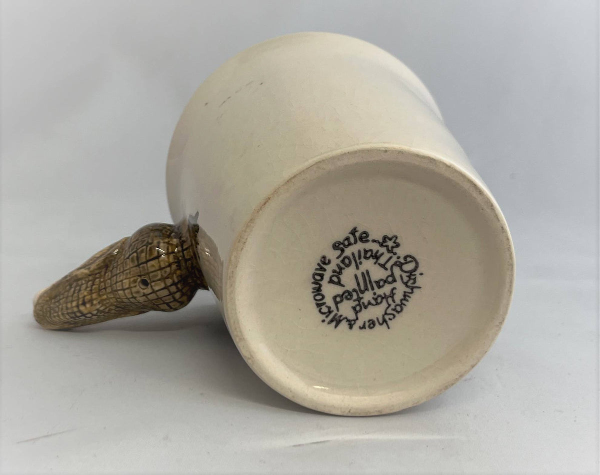 White ceramic mug with a textured handle on a light gray background