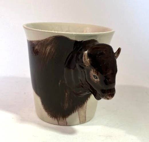 Ceramic mug with a bison head design on a white background