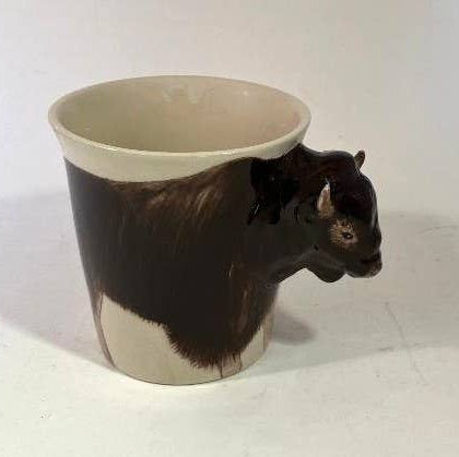 Ceramic mug shaped like a bison on a white background