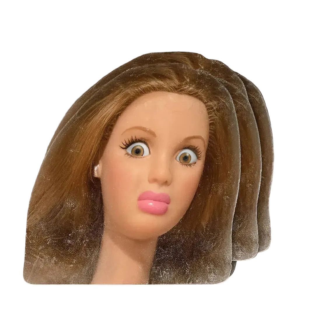 Mannequin head with brown hair on a wooden surface