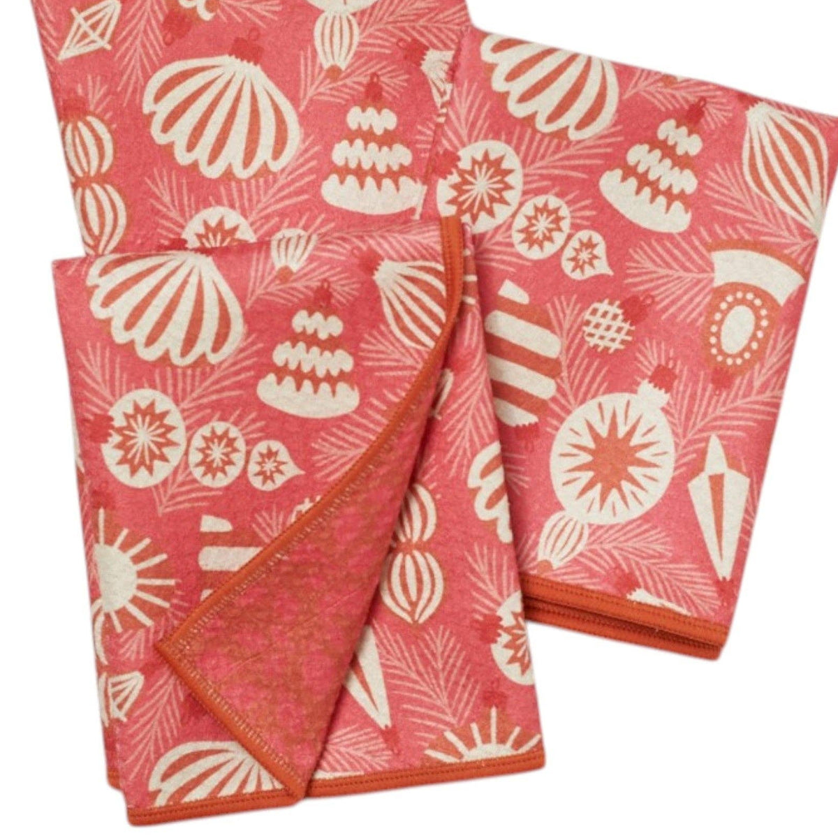Two pink towels with white shell pattern on a white background