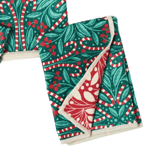 Set of three decorative towels with green, red, and white patterns on a white background