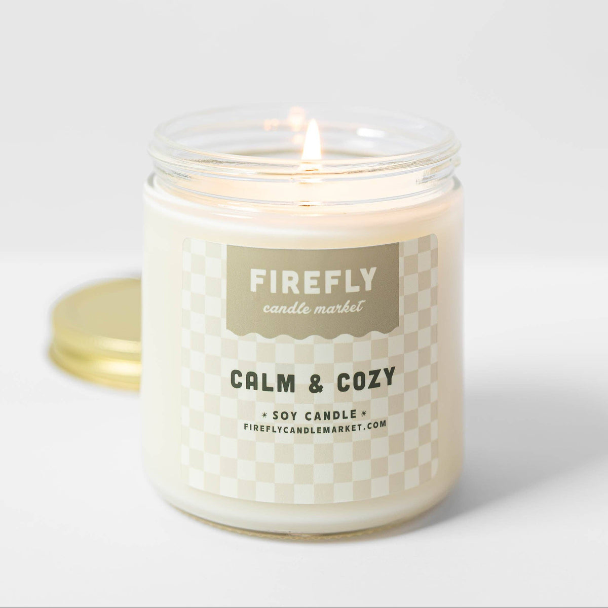Candle with 'Firefly Candle Market' label on a white background