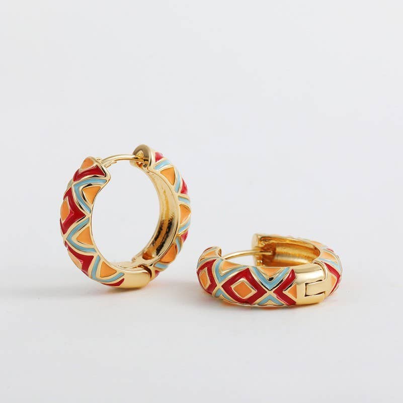 Gold hoop earrings with colorful geometric design on a light gray background