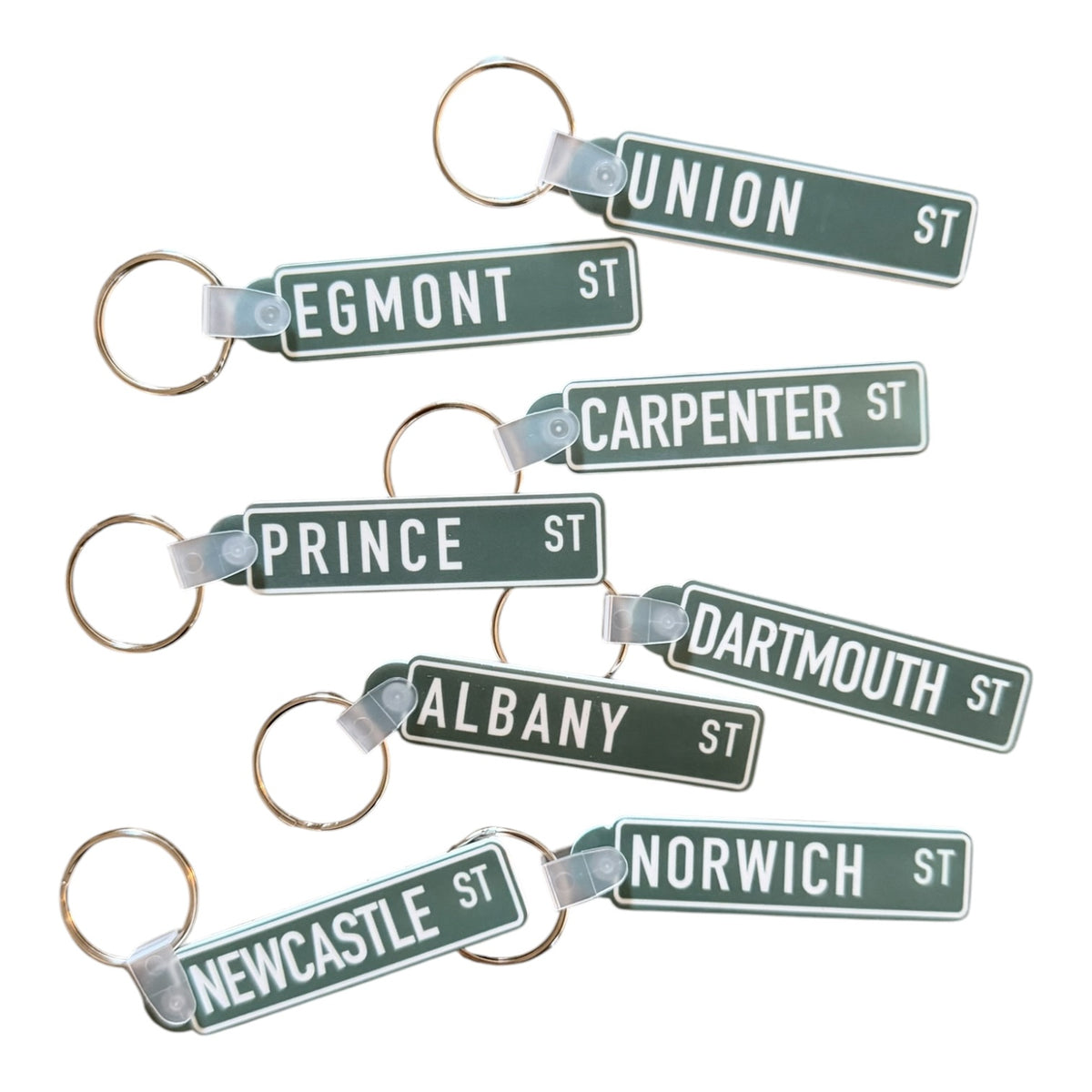 Set of street name keychains on a white background