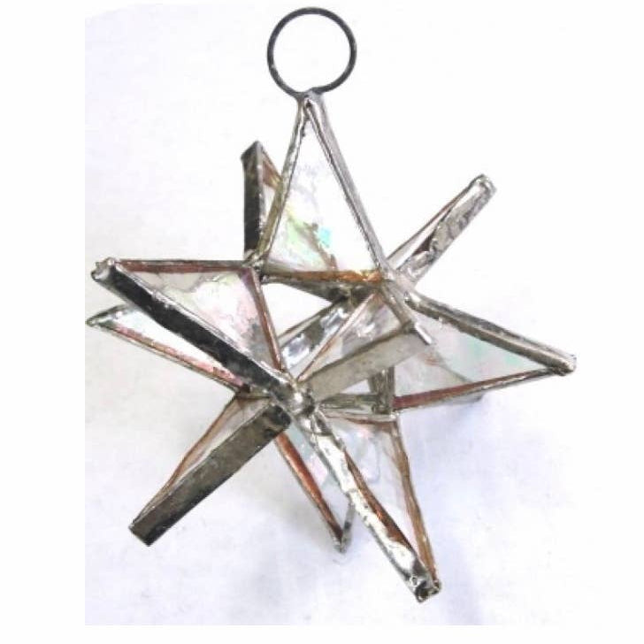 Star-shaped glass ornament with metallic accents on a white background