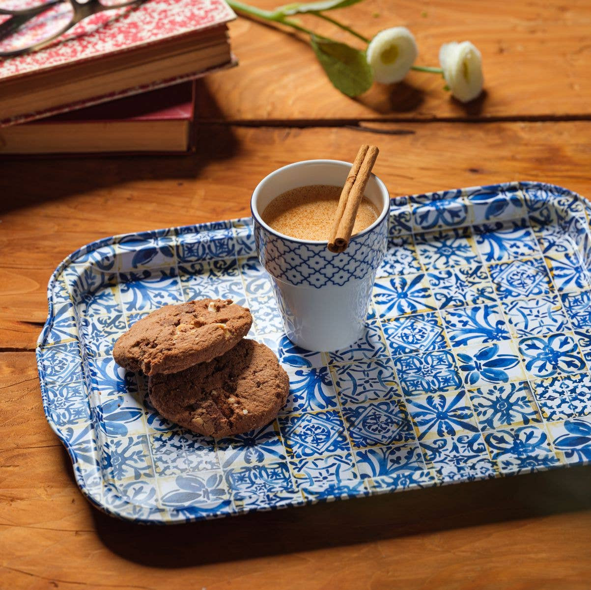 Cup of coffee with cookies on a decorative tray on a wooden table