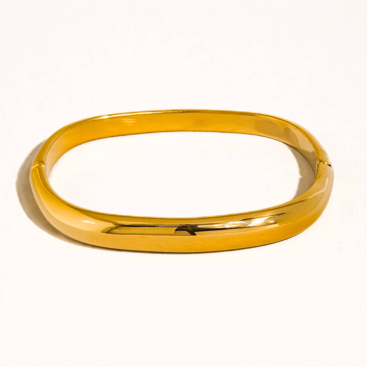 Gold bangle on a white background