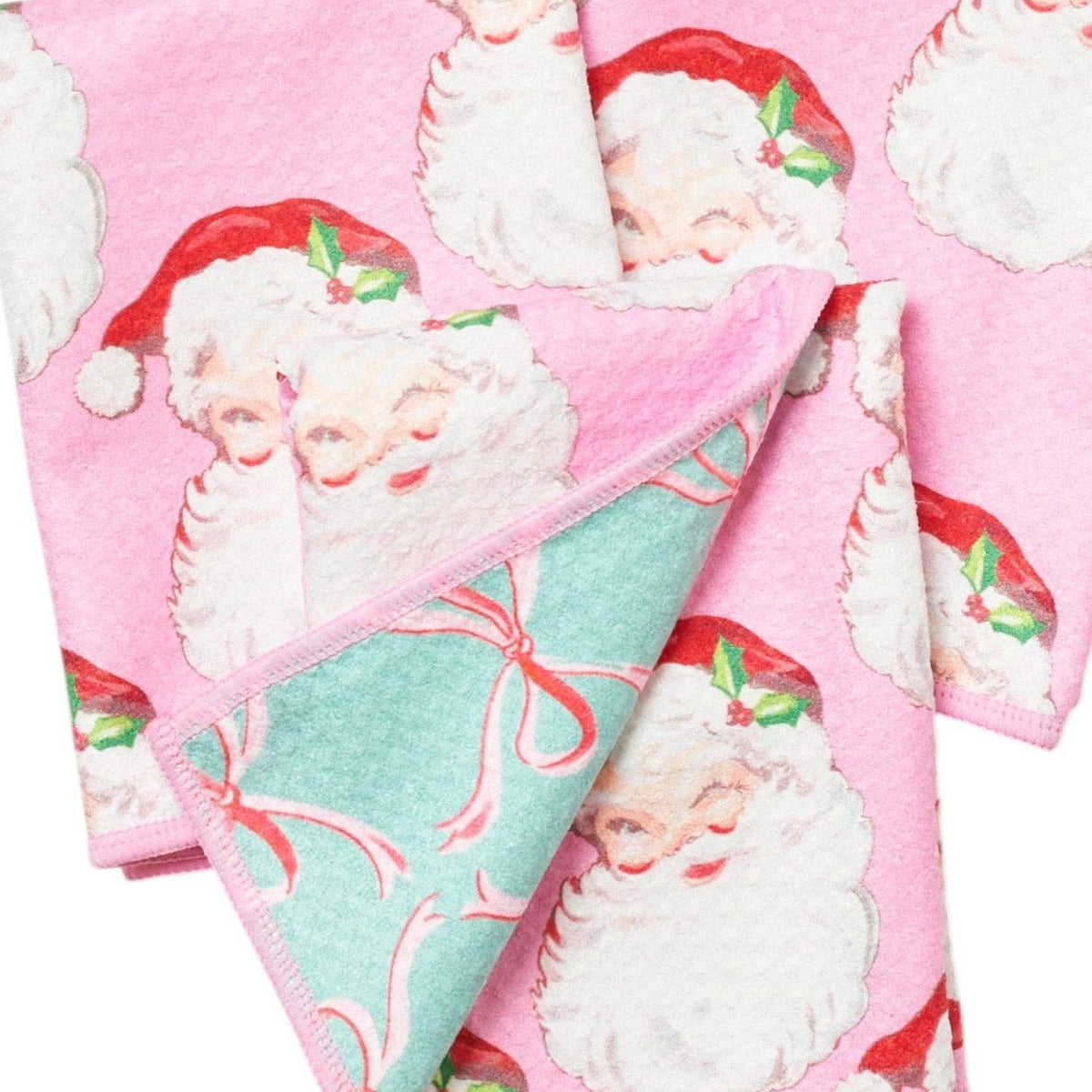 Set of pink dish clothes with Santa Claus designs on a white background