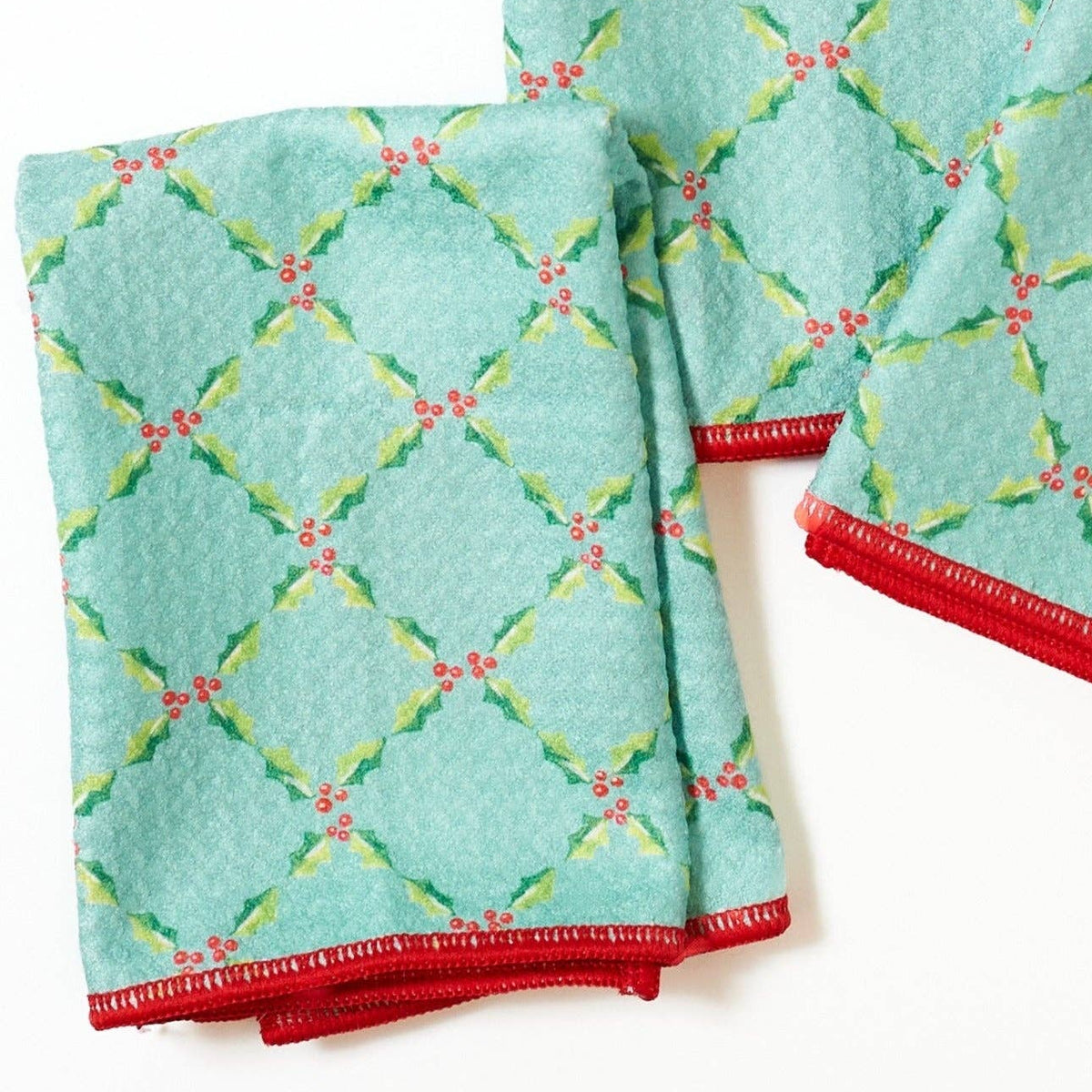 Two turquoise towels with geometric pattern on a white background