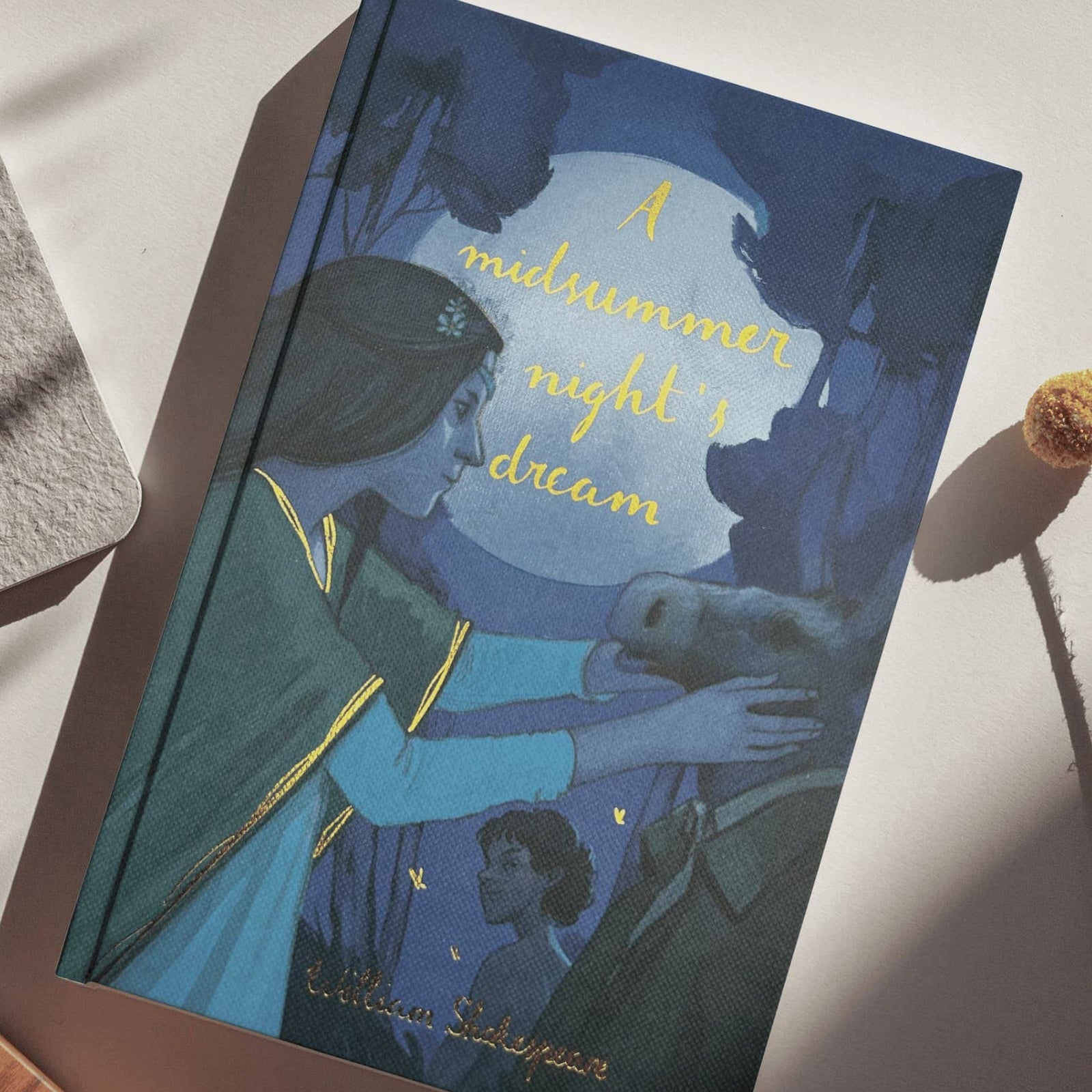 Book titled 'A Midsummer Night's Dream' by William Shakespeare on a white surface.