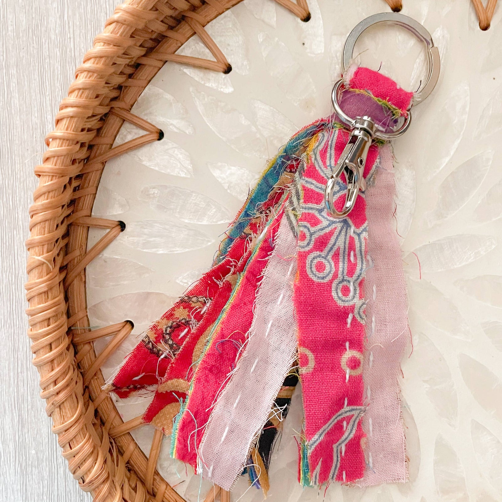 Colorful fabric keychain on a woven basket with a light background