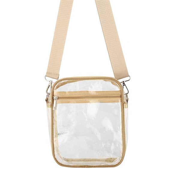 Clear crossbody bag with beige strap on a white background