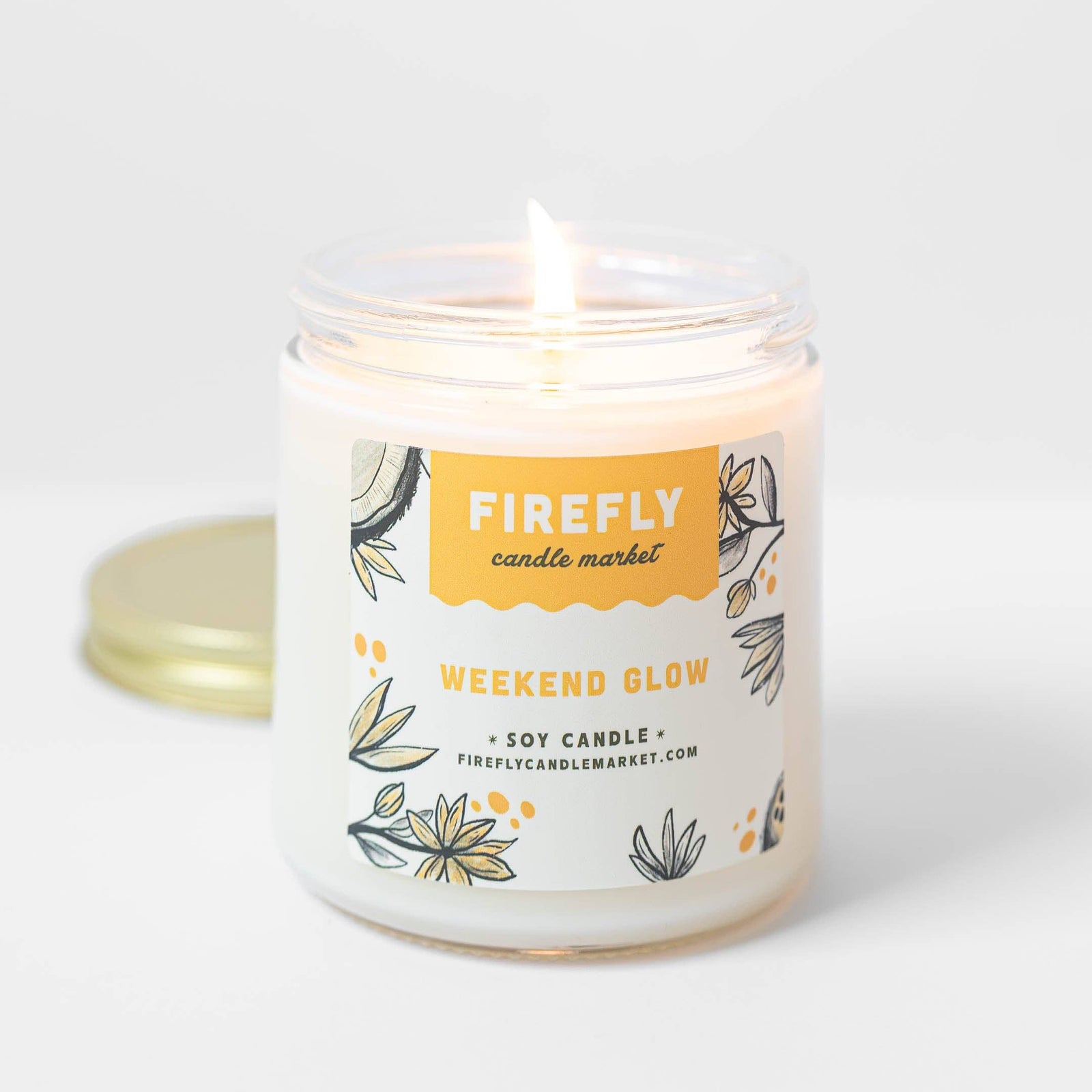 Candle with 'Firefly Candle Market' label on a white background