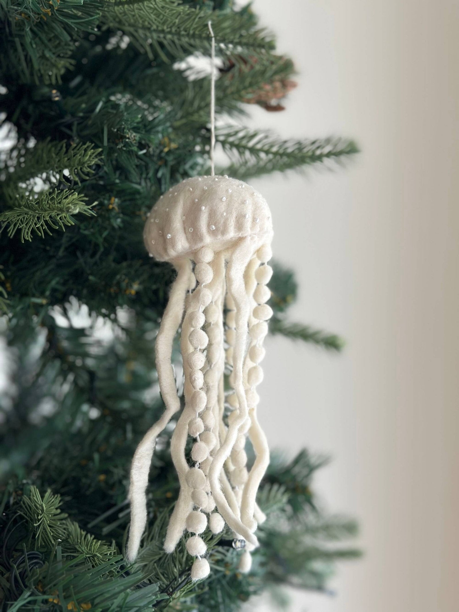 White jellyfish ornament on a Christmas tree