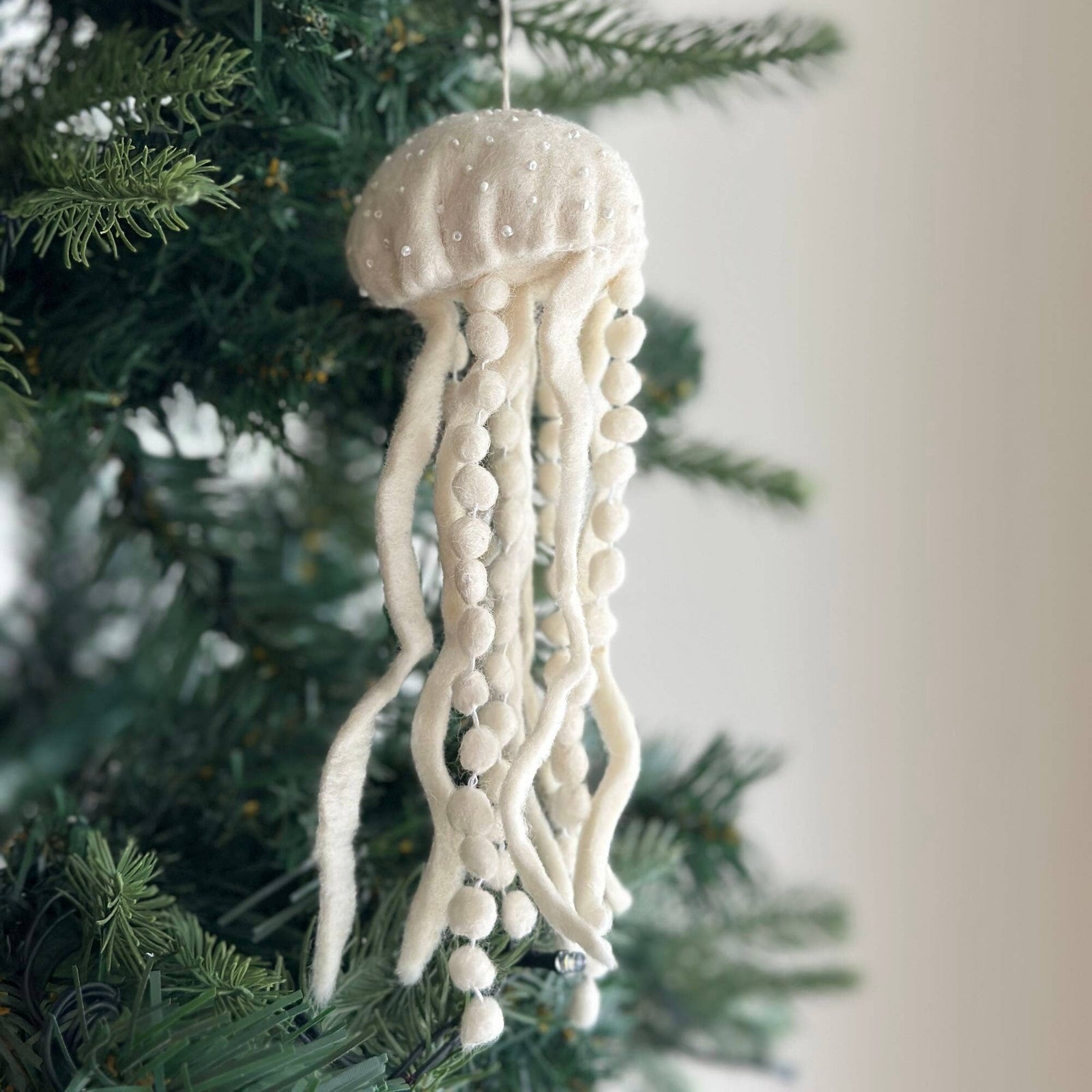 White jellyfish ornament on a Christmas tree
